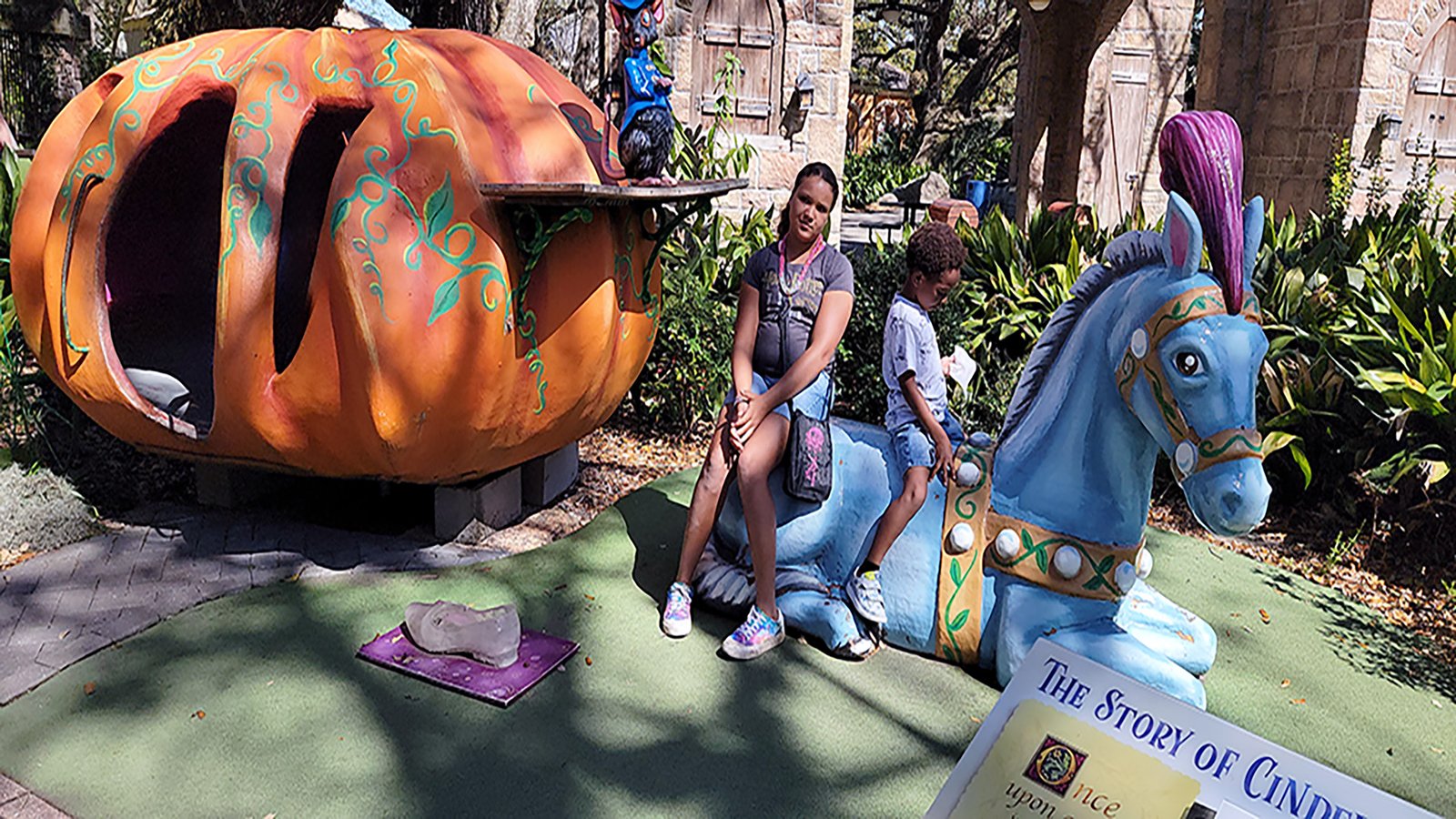 Zee and JJ on top of the Storyville turtle sign